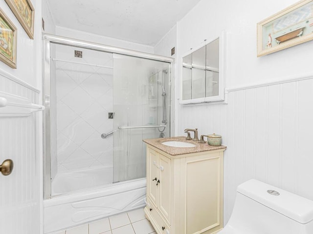 full bathroom with vanity, tile patterned flooring, toilet, and combined bath / shower with glass door