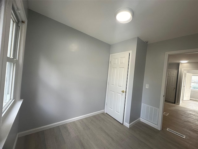 unfurnished bedroom with hardwood / wood-style flooring