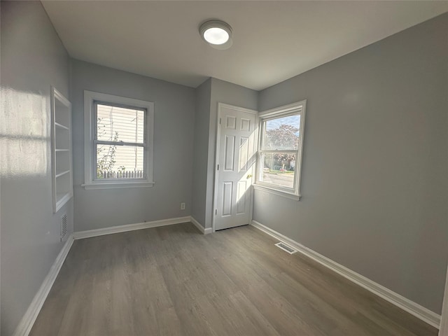 unfurnished room featuring hardwood / wood-style flooring