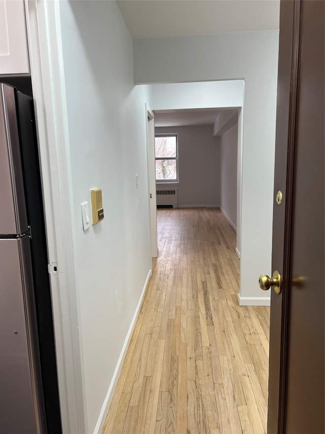 hall with radiator and light hardwood / wood-style floors