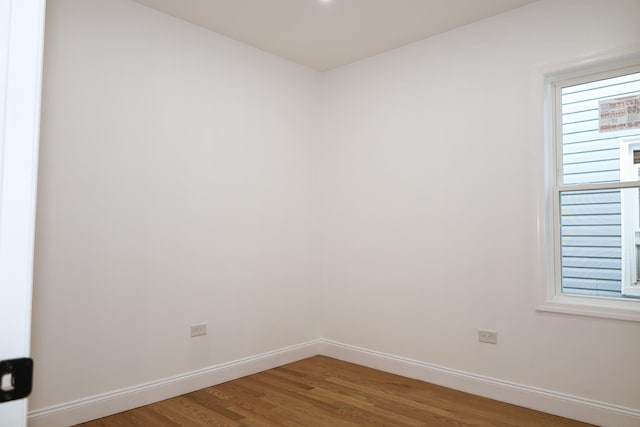 spare room with hardwood / wood-style floors