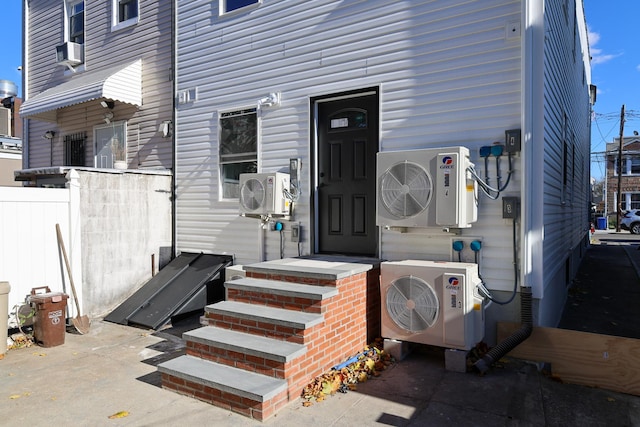 view of exterior entry with cooling unit and ac unit