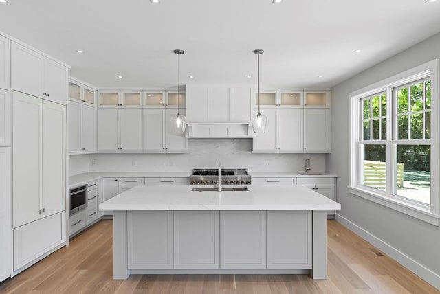 245 Mill Rd, Westhampton Beach, NY 11978 - kitchen featuring a sink, baseboards, light wood-type flooring, and recessed lighting