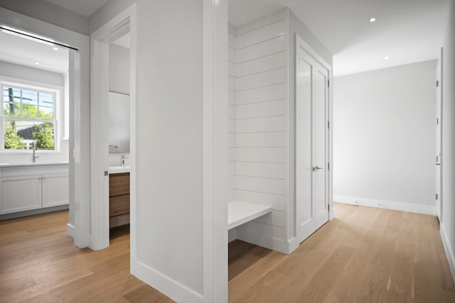245 Mill Rd, Westhampton Beach, NY 11978 - hall with light wood finished floors, baseboards, and recessed lighting