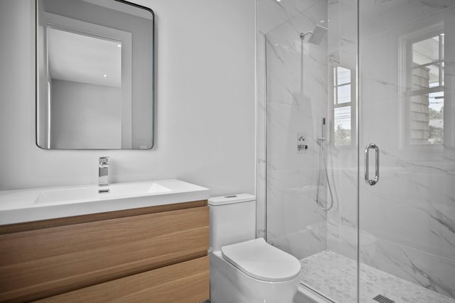 245 Mill Rd, Westhampton Beach, NY 11978 - bathroom with a marble finish shower, toilet, and vanity