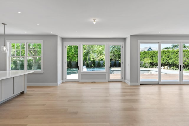 245 Mill Rd, Westhampton Beach, NY 11978 - unfurnished living room featuring light wood finished floors, baseboards, and recessed lighting