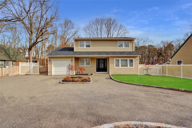 front of property featuring a garage and a front yard