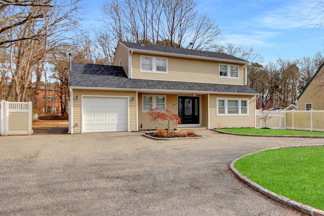 front facade with a garage and a front lawn