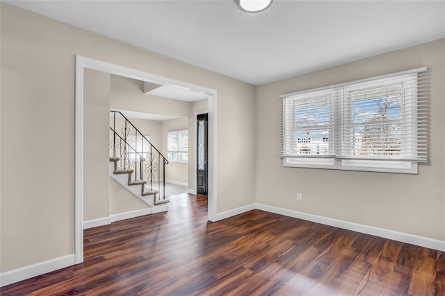 unfurnished room with dark hardwood / wood-style flooring