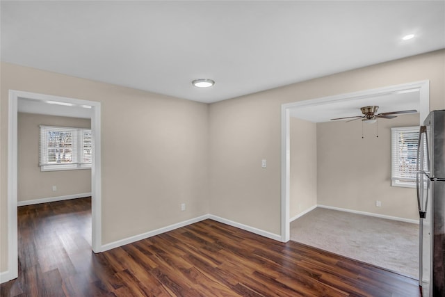 empty room featuring dark hardwood / wood-style floors and ceiling fan