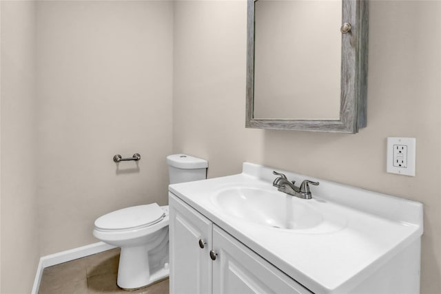 bathroom featuring vanity, tile patterned floors, and toilet