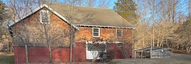 view of side of home with an outbuilding and a barn