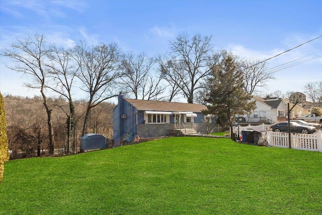 rear view of property with a lawn