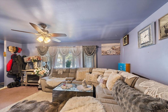 carpeted living room with ceiling fan