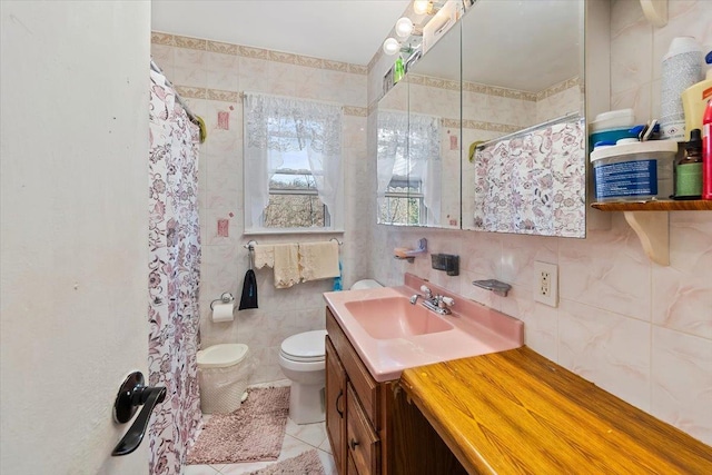 bathroom featuring tasteful backsplash, tile walls, tile patterned flooring, vanity, and toilet