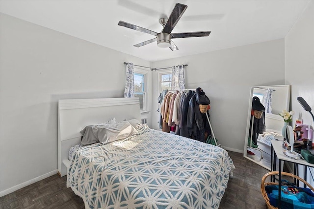 bedroom featuring ceiling fan and dark parquet floors