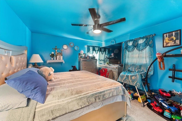 bedroom featuring ceiling fan and carpet