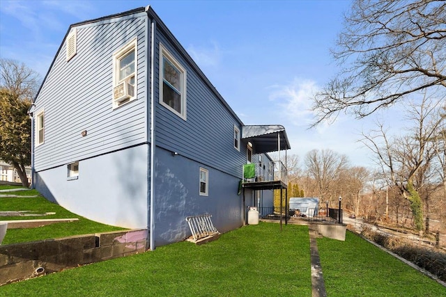 view of home's exterior with cooling unit and a yard