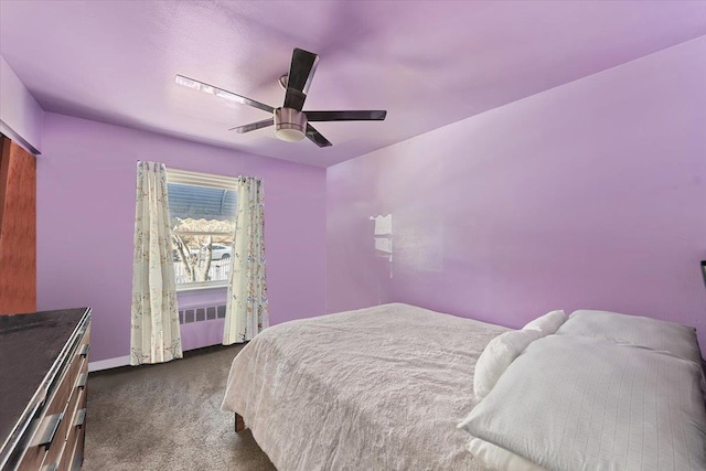 carpeted bedroom featuring ceiling fan and radiator heating unit