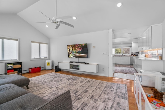 living room with a healthy amount of sunlight, light wood-style flooring, and recessed lighting