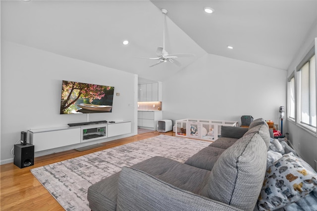 living room featuring baseboards, a ceiling fan, lofted ceiling, wood finished floors, and recessed lighting