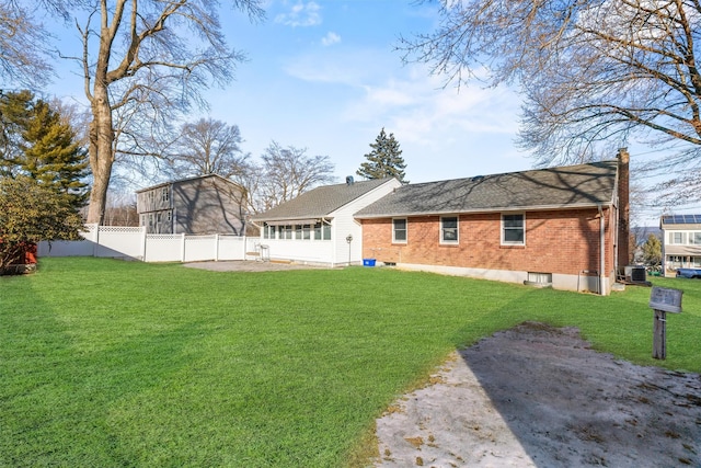 view of yard with fence and a sunroom