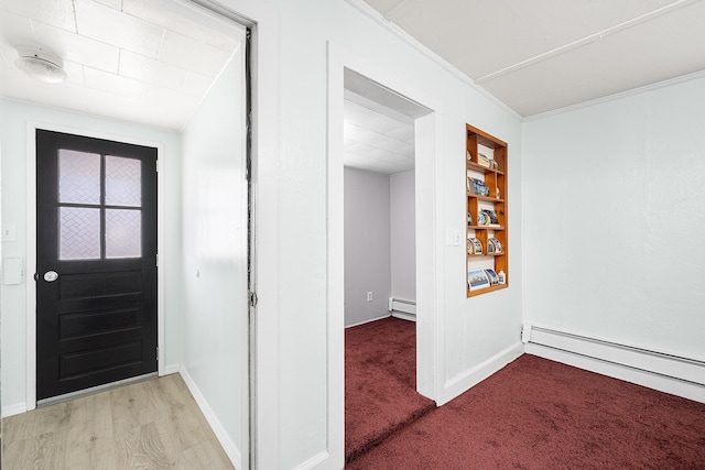 carpeted entryway with crown molding and a baseboard heating unit