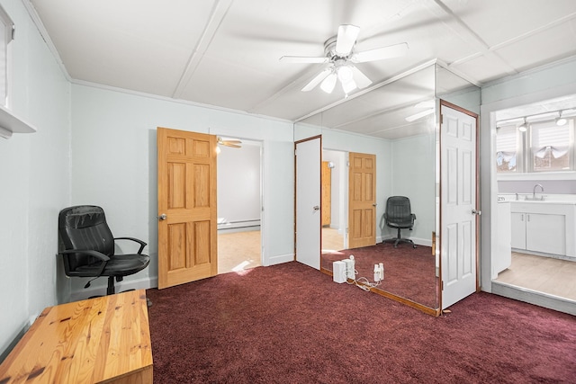 bedroom featuring baseboard heating, ceiling fan, sink, and carpet floors