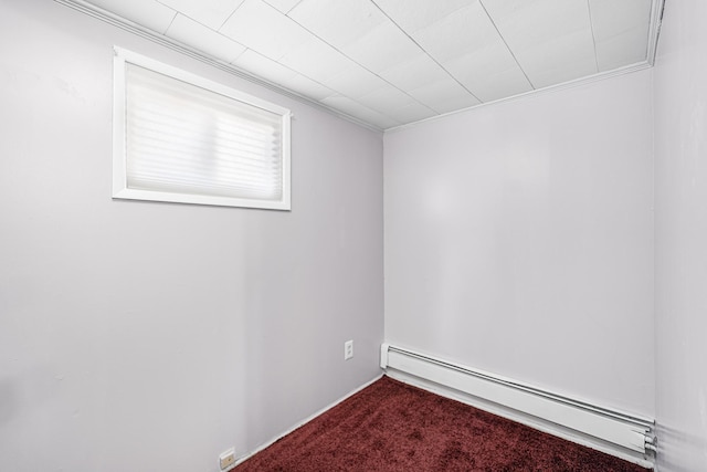 unfurnished room featuring a baseboard radiator, carpet, and crown molding