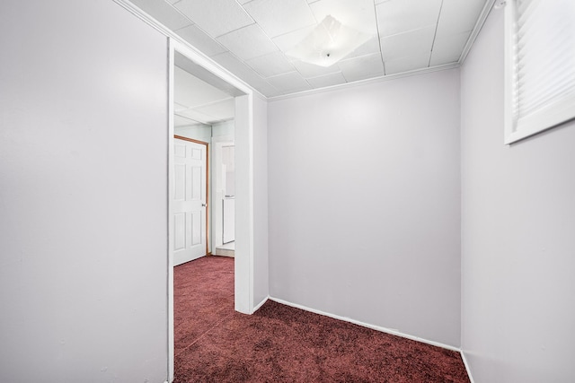 corridor featuring ornamental molding and dark carpet