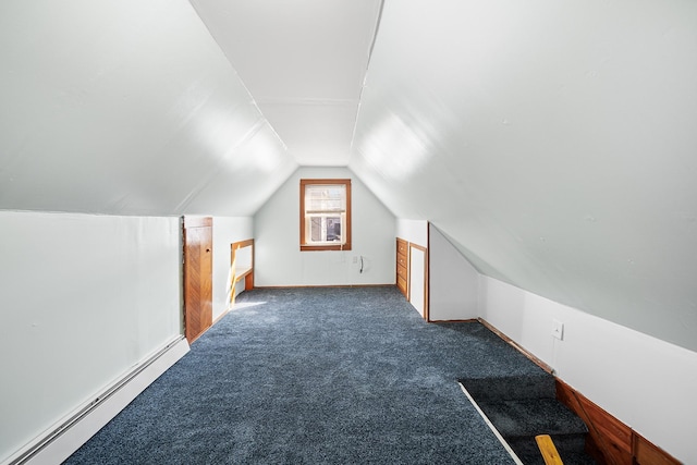 additional living space featuring a baseboard radiator, lofted ceiling, and dark carpet