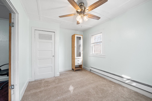 unfurnished bedroom with a baseboard radiator, light colored carpet, and ceiling fan