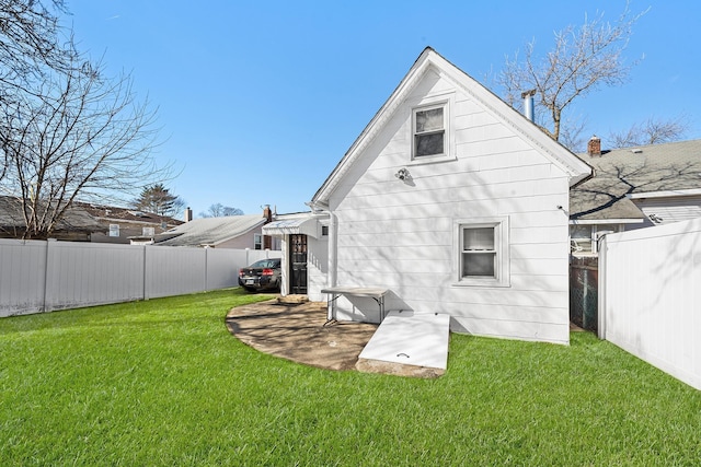 back of house with a lawn