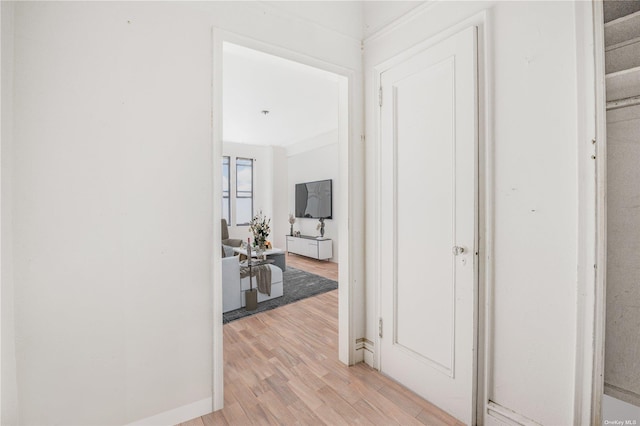 corridor with light hardwood / wood-style floors