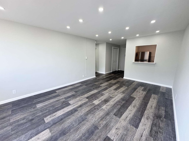 spare room featuring baseboards and recessed lighting