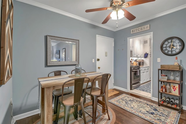 dining space with hardwood / wood-style flooring, ceiling fan, and ornamental molding