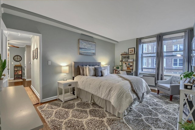 bedroom with hardwood / wood-style floors and cooling unit