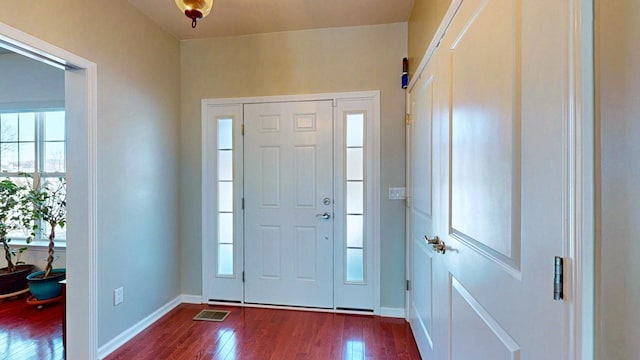 entryway featuring dark wood-style floors, visible vents, and baseboards