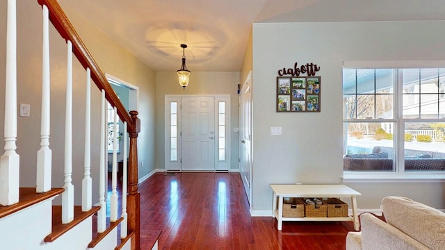 foyer entrance featuring stairway, dark wood finished floors, and baseboards