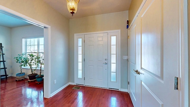 entryway featuring baseboards, visible vents, and dark wood-type flooring