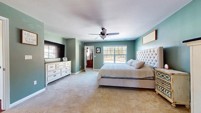 bedroom featuring ceiling fan, baseboards, and light colored carpet