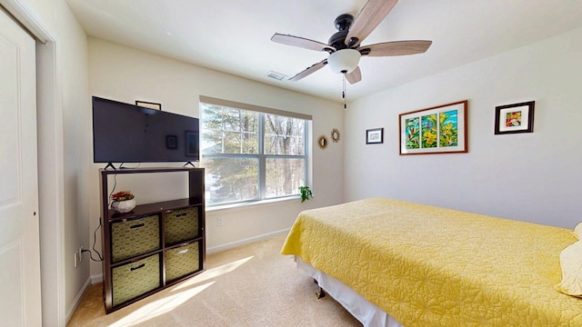 bedroom featuring visible vents, baseboards, ceiling fan, and light colored carpet