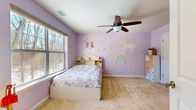 bedroom with visible vents, multiple windows, light carpet, and baseboards