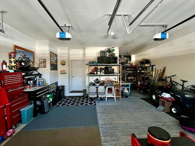 garage with a garage door opener and a workshop area