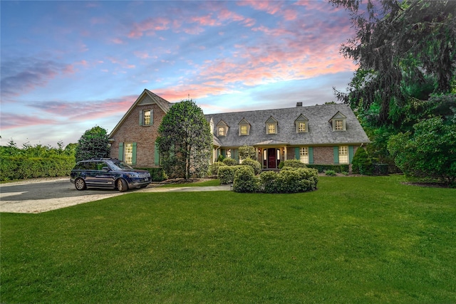 new england style home with a yard