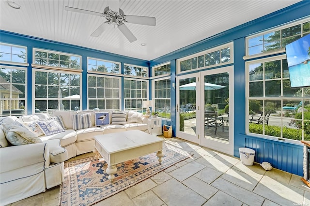 unfurnished sunroom featuring a wealth of natural light and ceiling fan