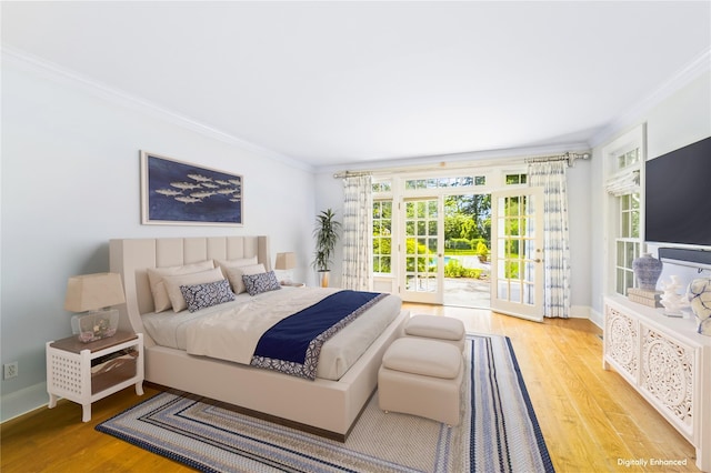 bedroom featuring crown molding, light hardwood / wood-style flooring, and access to outside