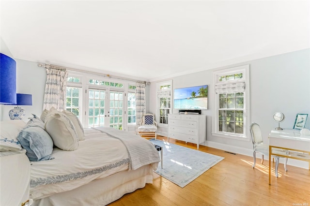 bedroom featuring hardwood / wood-style floors and french doors