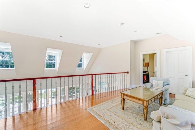 sitting room featuring lofted ceiling and hardwood / wood-style flooring