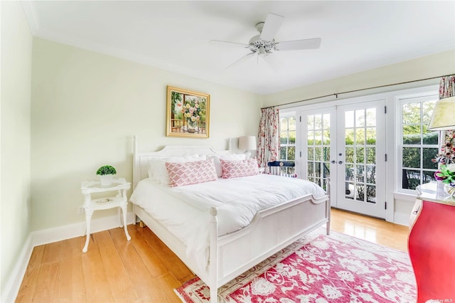 bedroom featuring hardwood / wood-style flooring, ceiling fan, french doors, and access to outside